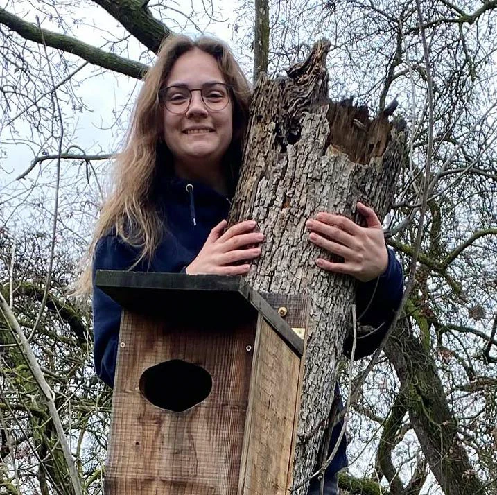 instructor holding on to a tree